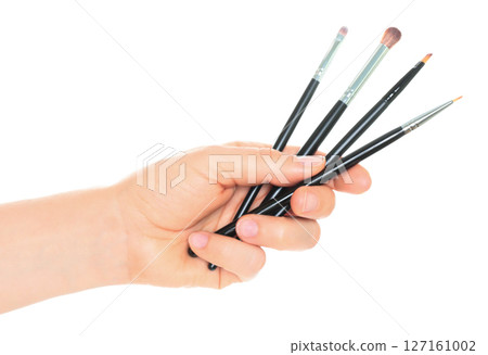 Woman hand holds Cosmetics Brushes, isolated on transparent background, cosmetics and visage concept 127161002