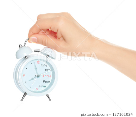 Woman hand holds white Alarm Clock, isolated on transparent background, time and home things concept Woman hand holds white Alarm Clock, isolated on transparent background, time and home things concept 127161024