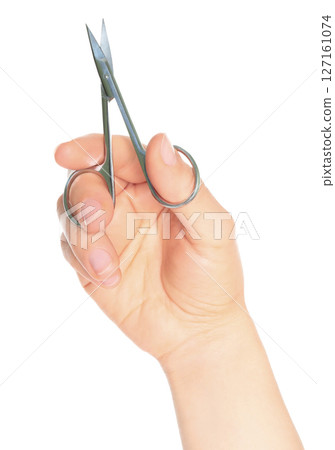 Woman hand holds cosmetic scissors, isolated on transparent background, cosmetic tools concept 127161074