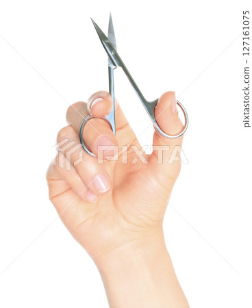 Woman hand holds cosmetic scissors, isolated on transparent background, cosmetic tools concept Woman hand holds cosmetic scissors, isolated on transparent background, cosmetic tools concept 127161075