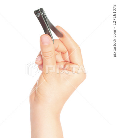Woman hand holds manicure nail clipper, isolated on transparent background, cosmetic tools concept Woman hand holds manicure nail clipper, isolated on transparent background, cosmetic tools concept 127161078