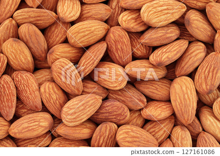 Background of Almonds nuts close-up, natural and healthy food concept for backgrounds and backdrops 127161086