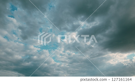 Dramatic Cloudy Skies with Beautiful Light Blue Patches, a Truly Captivating Sight 127161164