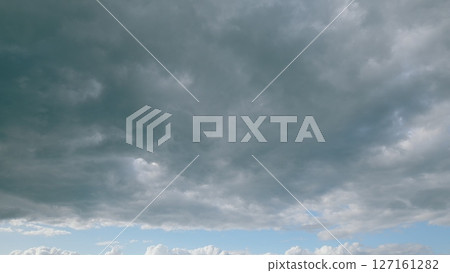 This image captures a Dramatic Cloudy Sky with Beautiful Blue Highlights in vivid detail 127161282