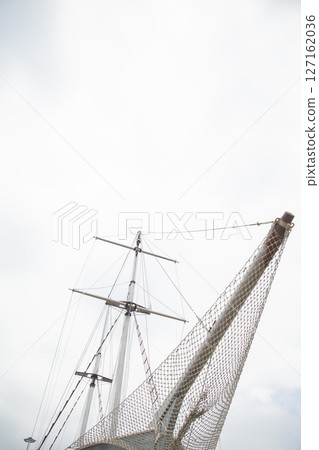 masts of a wooden sailing ship in the roadstead masts of a wooden sailing ship in the roadstead 127162036