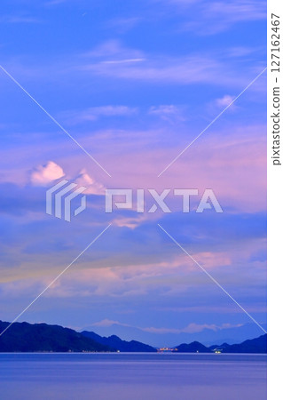 View of the Tobishima Kaido and Shikoku Mountains from Oshiba Island at dusk 127162467