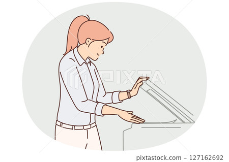 Woman office worker uses copy machine to scan document or fax paper to conclude agreement 127162692