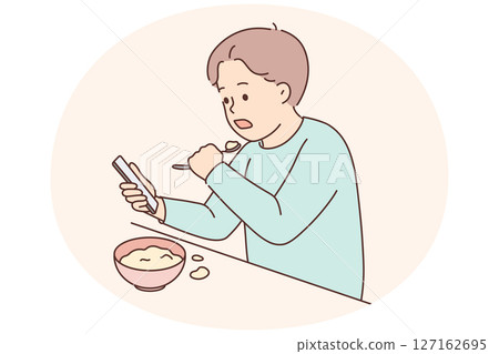 Child eat watching cartoons on cellphone 127162695