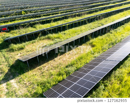 Aerial view of solar power station on a green field. Sustainable development. Aerial view of solar power station on a green field. Sustainable development. 127162935