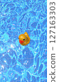 A Cute and Cheerful Yellow Rubber Duck Joyfully Floating in a Bright Blue Pool on a Sunny Day 127163303