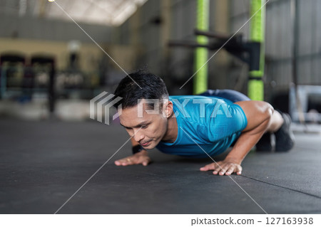 Man Engaged in Push-Up Exercise at Gym Man Engaged in Push-Up Exercise at Gym 127163938