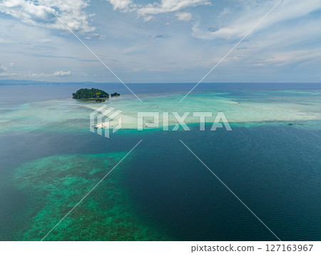 Aerial view of Islets surrounded by blue sea. Vanishing Island and Turtle Island in Barobo, Surigao del Sur. Philippines. Aerial view of Islets surrounded by blue sea. Vanishing Island and Turtle Island in Barobo, Surigao del Sur. Philippines. 127163967