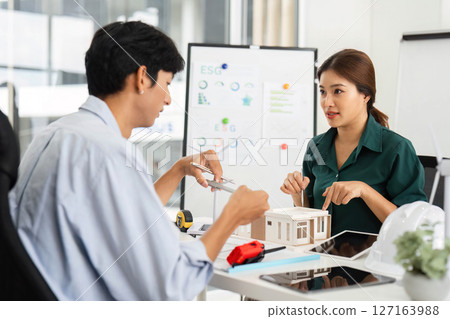 Sustainable Solutions. Professionals collaborating on ESG projects with models and innovative ideas. 127163988