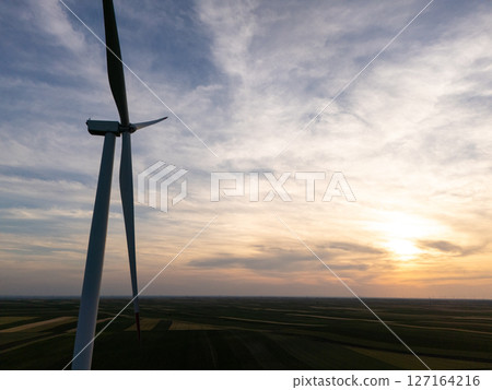 Silhouette of wind turbine at sunset Silhouette of wind turbine at sunset 127164216