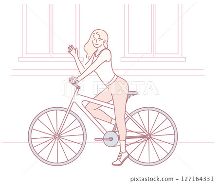 A Stylish Woman Riding a Bicycle Gracefully in a Vibrant Urban Environment Setting 127164331