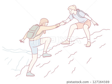 Two friends working together to assist each other in a challenging mountain climb adventure 127164389