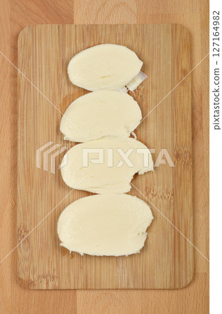 Slices of fresh mozzarella cheese Slices of fresh mozzarella cheese 127164982