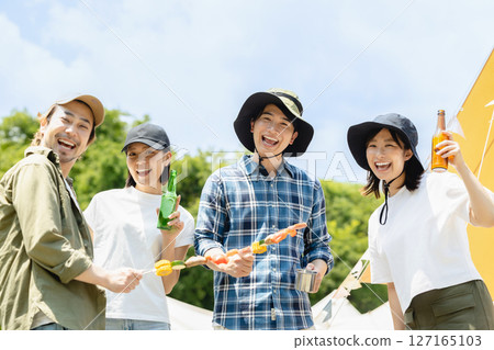 Young people enjoying camping 127165103