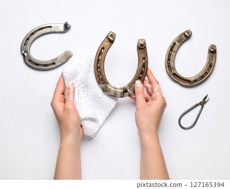 Cleaning Horseshoes with a White Cloth Cleaning Horseshoes with a White Cloth 127165394