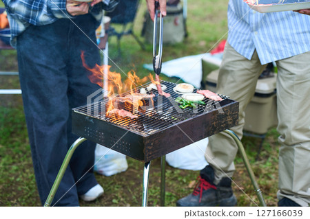 Camping, outdoor, barbecue, BBQ, grilled meat, charcoal fire 127166039