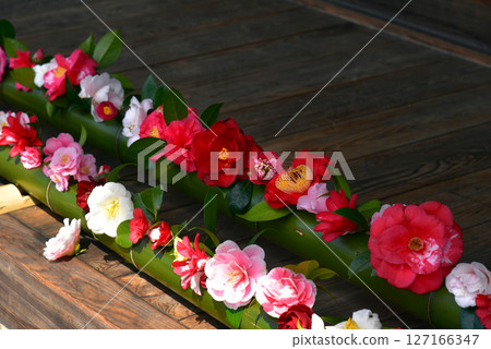 Camellia flowers in a bamboo vase 127166347