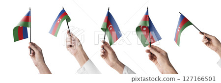 The Azerbaijan flag in hand in different angles on a white background The Azerbaijan flag in hand in different angles on a white background 127166501