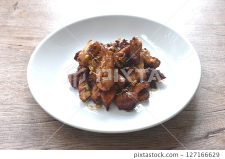 fried slice chicken meat with salt and garlic on plate fried slice chicken meat with salt and garlic on plate 127166629