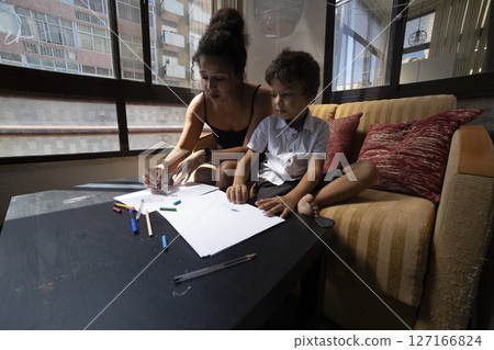 Mother and son drawing with crayons at home Mother and son drawing with crayons at home 127166824
