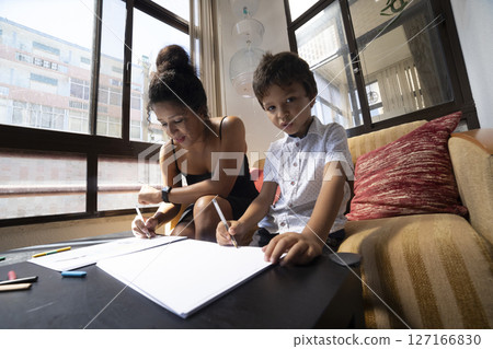Mother and son engaging in creative drawing together Mother and son engaging in creative drawing together 127166830