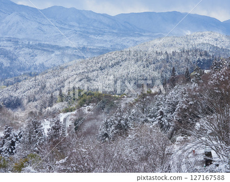 Snowy scenery of Mt. Ena seen from the observation deck of Magome-juku, a tourist spot on the Nakasendo road in winter Snowy scenery of Mt. Ena seen from the observation deck of Magome-juku, a tourist spot on the Nakasendo road in winter 127167588