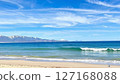 Sandy beach with a view of snowy mountains 127168088