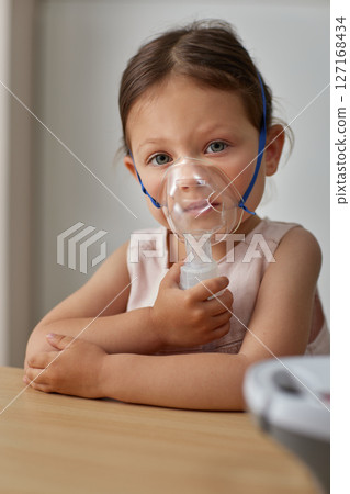cute little toddler girl making inhalation with nebulizer 127168434