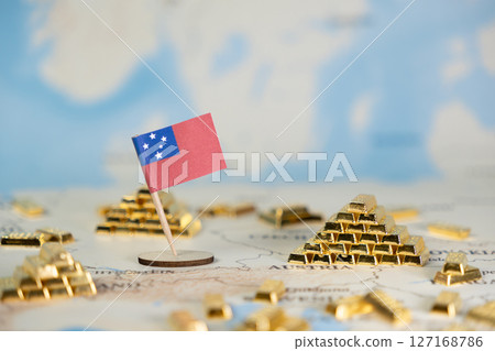 Samoan flag standing on a world map surrounded by gold bars, representing national wealth, global economy, and international financial investment concepts Samoan flag standing on a world map surrounded by gold bars, representing national wealth, global economy, and international financial investment concepts 127168786
