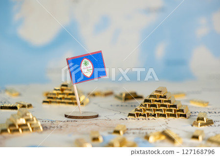 Guam national flag on a map with numerous shining gold bars, symbolizing the island's economic development, wealth, and global trade relations, featuring copy space Guam national flag on a map with numerous shining gold bars, symbolizing the island's economic development, wealth, and global trade relations, featuring copy space 127168796