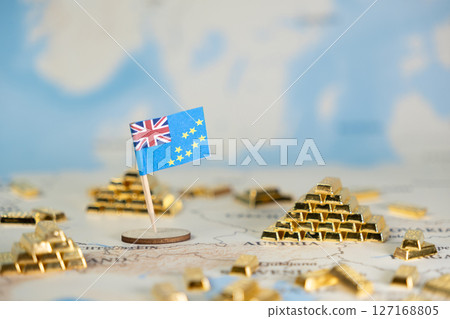 Tuvalu flag and miniature gold bars placed on a world map, symbolizing national wealth, global finance, and investment potential 127168805
