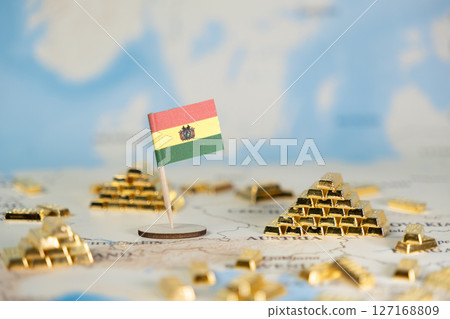 Bolivian national flag stands on a map surrounded by glittering gold bars, representing global financial assets and national economic prosperity with ample copy space Bolivian national flag stands on a map surrounded by glittering gold bars, representing global financial assets and national economic prosperity with ample copy space 127168809