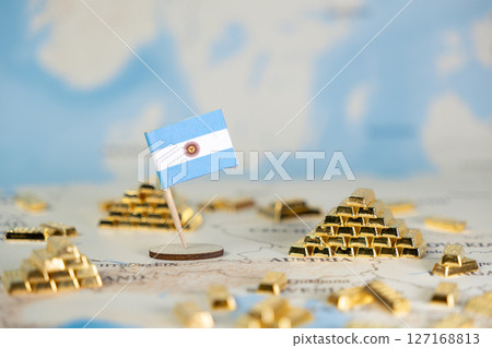 Argentinian flag and gold bar piles on a world map symbolize national wealth, economic stability, global finance, and commodity trade with copy space Argentinian flag and gold bar piles on a world map symbolize national wealth, economic stability, global finance, and commodity trade with copy space 127168813