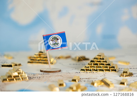 Belize flag standing on a world map with scattered gold bars, symbolizing national wealth, economic growth, and global financial opportunities, with ample copy space 127168816