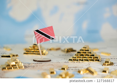 Trinidad and Tobago flag stands with golden bar pyramids on global map, illustrating national wealth, economic resources, and international investment potential 127168817