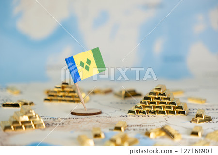 Saint Vincent and the Grenadines flag pin on a global map, surrounded by miniature gold bars, symbolizing national wealth, economic growth, and global investment 127168901