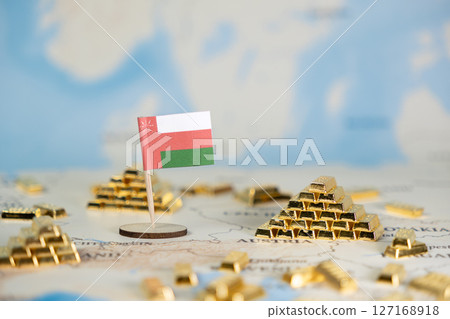 Oman flag with miniature gold bars on a world map, symbolizing national economic prosperity, global wealth, and potential investment, offering clear copy space 127168918