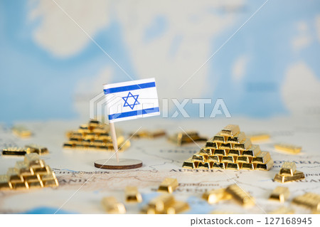 Israeli flag standing with golden bars on a world map, symbolizing national wealth, economic stability, and financial reserves, offering ample copy space 127168945