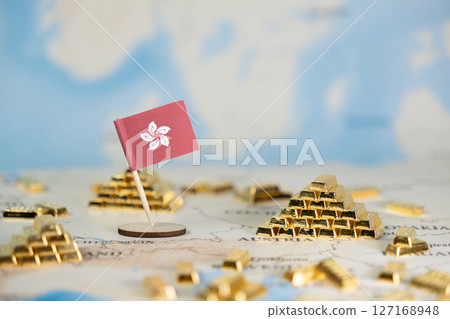 Hong Kong flag stands on a world map amidst gold bars, symbolizing global financial wealth, economic growth, and international investment opportunities 127168948