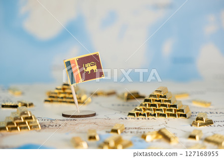 Sri Lanka flag stands on a detailed world map amidst gleaming gold bars, symbolizing national financial wealth, economic stability, and global investment with ample copy space 127168955