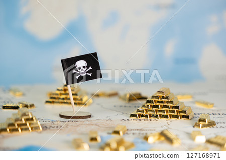 Pirate flag and scattered gold bars on a world map symbolize pervasive global digital piracy, cybercrime, and financial fraud risks Pirate flag and scattered gold bars on a world map symbolize pervasive global digital piracy, cybercrime, and financial fraud risks 127168971