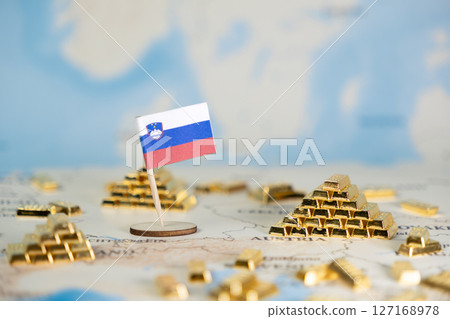 Slovenia's flag on a global map with miniature gold bars symbolizing national economic strength, financial prosperity, and resource management, ample copy space Slovenia's flag on a global map with miniature gold bars symbolizing national economic strength, financial prosperity, and resource management, ample copy space 127168978