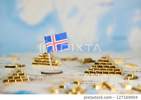 Miniature flag of Iceland on a world map with gold bars, symbolizing national wealth, economic stability, and global investment opportunities, with ample copy space 127169004