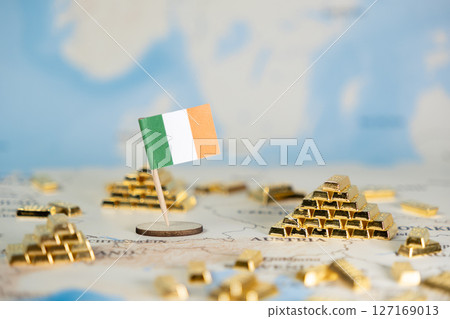Ireland national flag on a world map with gold bars symbolizes the country's economic strength, national wealth, and financial stability, offering useful copy space 127169013