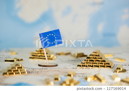 European Union flag positioned on a world map, surrounded by numerous glistening gold bar stacks, powerfully symbolizing substantial economic stability and financial wealth, offering wide copy space 127169014