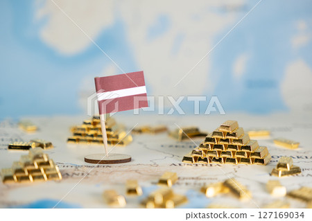 Latvian flag and gold bars on a global map, symbolizing national wealth, economic growth, secure investment, and financial strategy with room for text Latvian flag and gold bars on a global map, symbolizing national wealth, economic growth, secure investment, and financial strategy with room for text 127169034